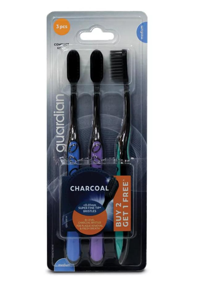 Package of three Guardian Charcoal toothbrushes with medium bristles, displayed in a clear plastic packaging.