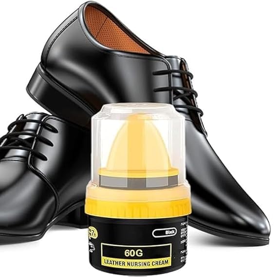 Black leather shoes displayed alongside a yellow shoe polish container and sponge for maintenance and repair.