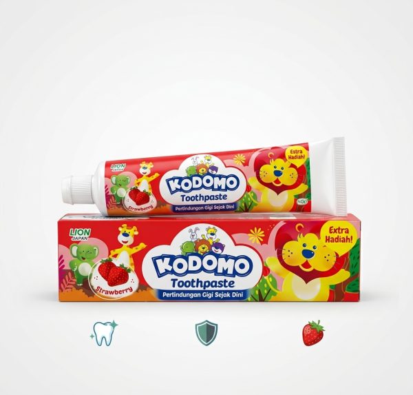Kodomo Baby Toothpaste in strawberry flavor, 45g, displayed with fresh strawberries beside the tube.